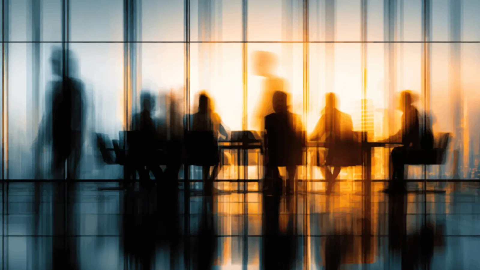 A meeting at dusk against a city skyline