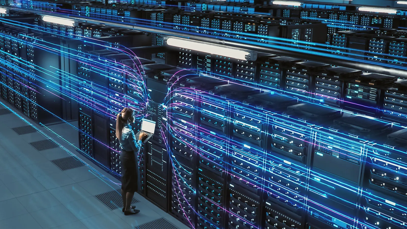 Two engineers with a laptop in a server room