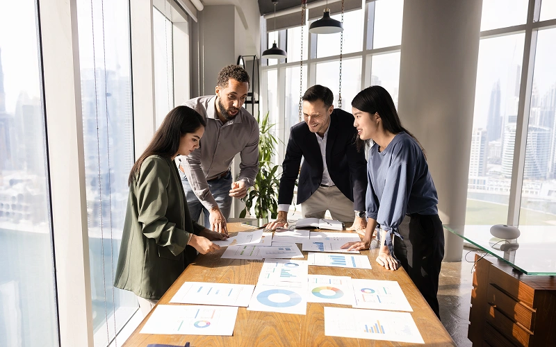 Advisory team reviewing reports in a Dubai office
